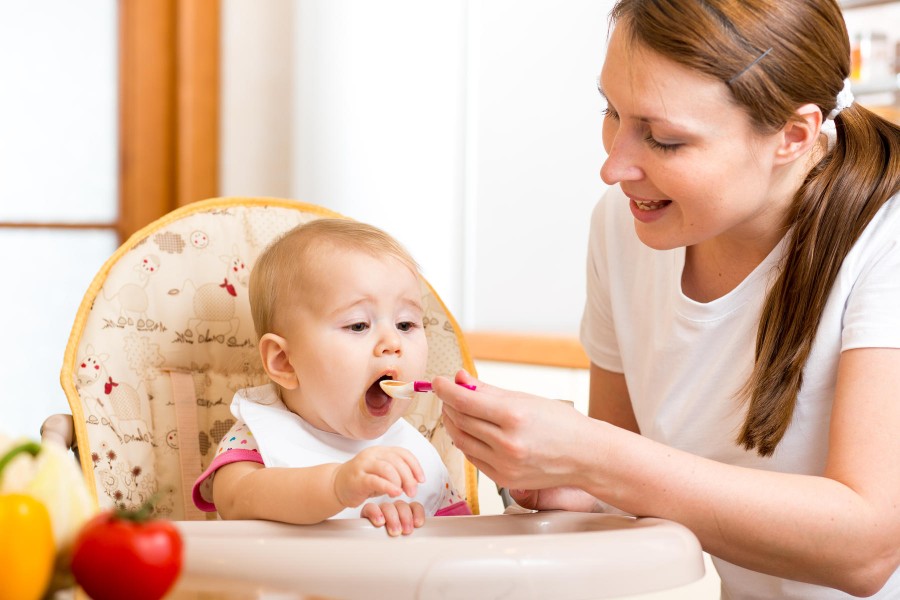 At five months babies will be able to take small amounts of pureed food from a spoon.